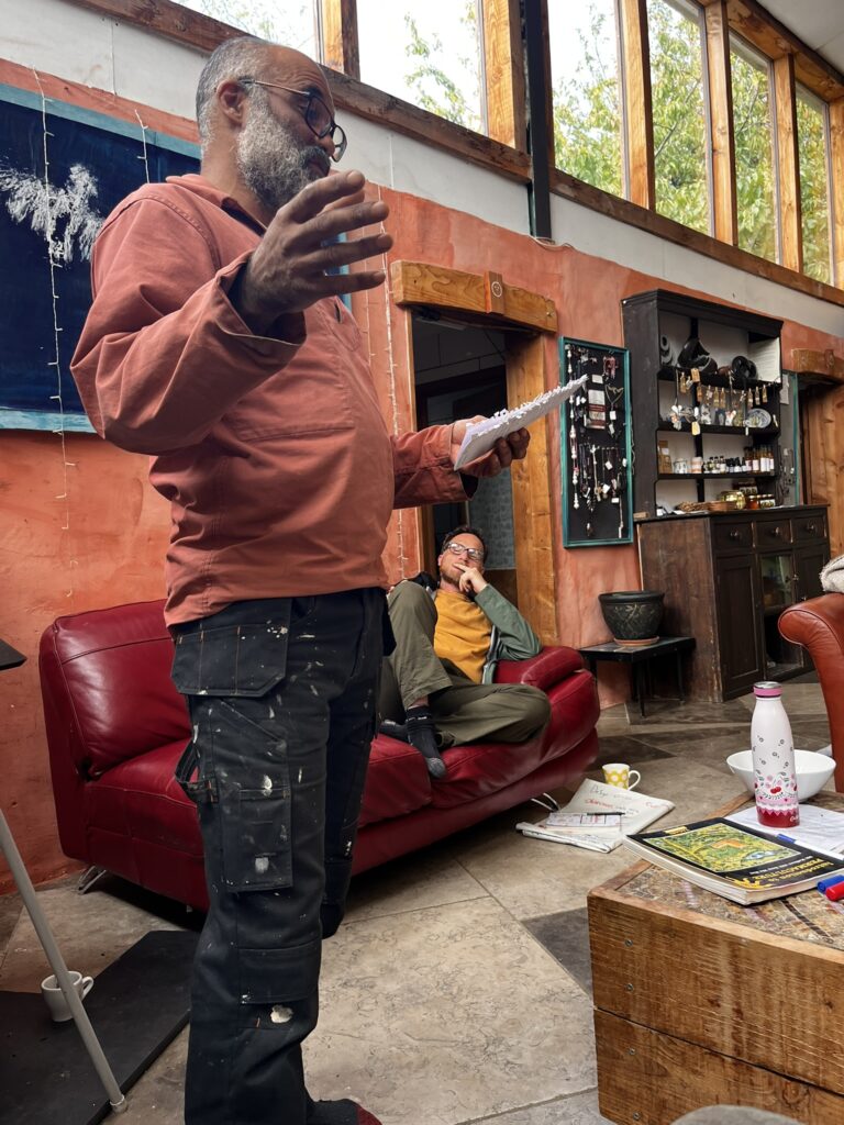 A participant talking through their permaculture design in the barn at Coed Hills