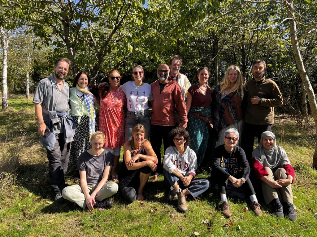The September immersion group together on the grass among the trees at Coed Hills
